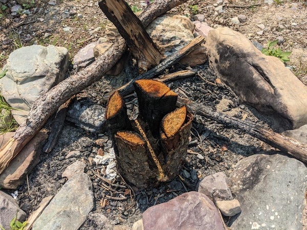 What is this oddly burned log I found at a campsite?

A: Swedish log burning….burns longer than firing a log onto a fire.