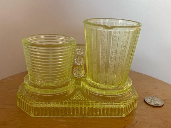 What is this two attached differently sized cups made of (probably) uranium/vaseline glass?

A: It’s a vintage smoke set for cigarettes and matches