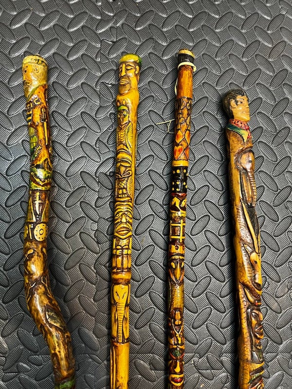 Celtic(?) ornate sticks, different lengths, with the year “1966-7” written on.

A: Walking sticks are a touristic item sold in many places. Some people collect them.