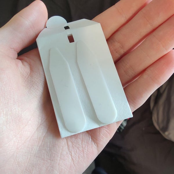 Bought a new shirt. This small packet was attached with the tags. What are these for?

A: Collar stiffeners . You can insert them in your collar to keep it stiff.