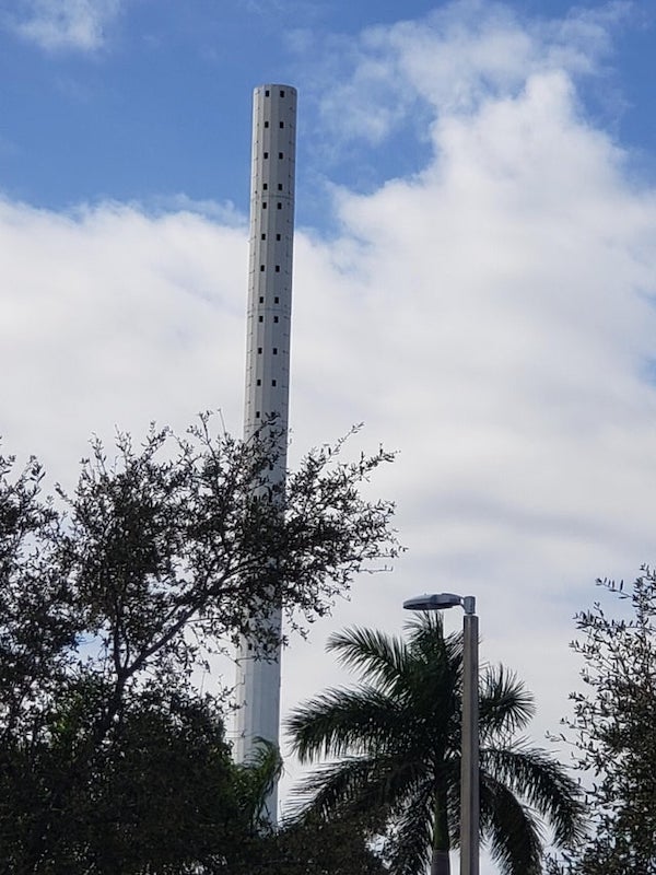 What is this tower in the middle of a shopping center?

A: Cell tower.