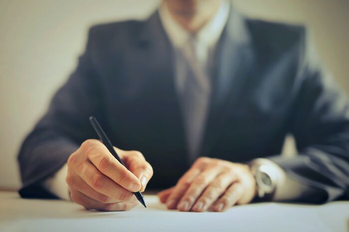 divorce stories - worst divorces - business man signing paper