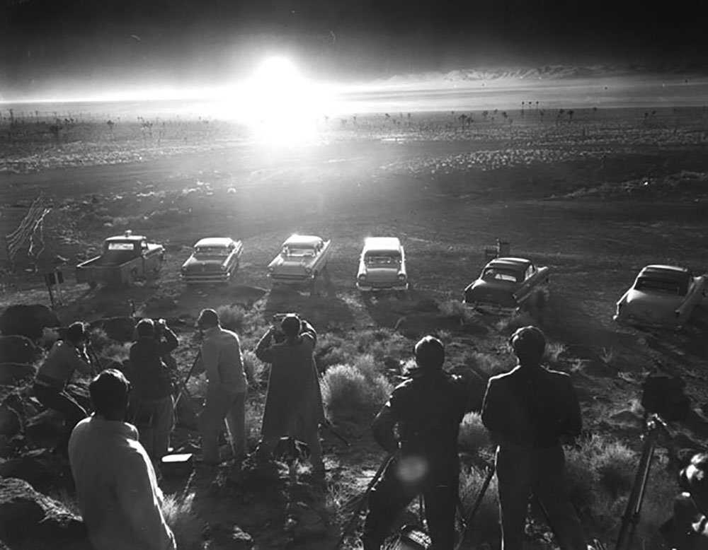 Reporters and photographers observe an atomic bomb blast at the Nevada Test Site, April 22, 1952