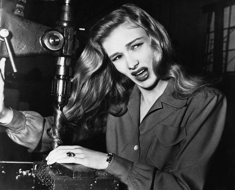 Actress Veronica Lake illustrates what can happen to women war workers who wear their hair long while working at their benches, in a factory somewhere in America, on November 9, 1943