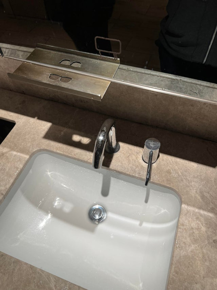 This bathroom has an eyeglass shelf you can use while you wash your face.
