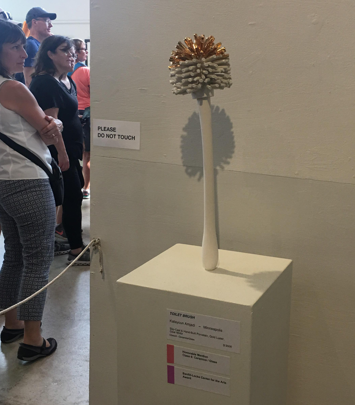 “A gold plated toilet brush sculpture, apparently worth thousands of dollars.”