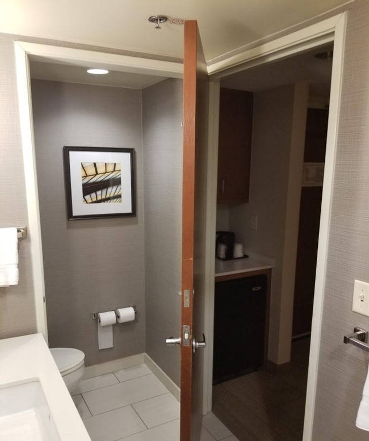 “This door in my hotel bathroom can close off either of 2 doorways.”