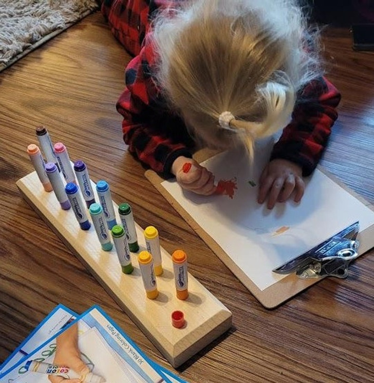 “Drill holes in a piece of wood and glue the caps of markers into them.”