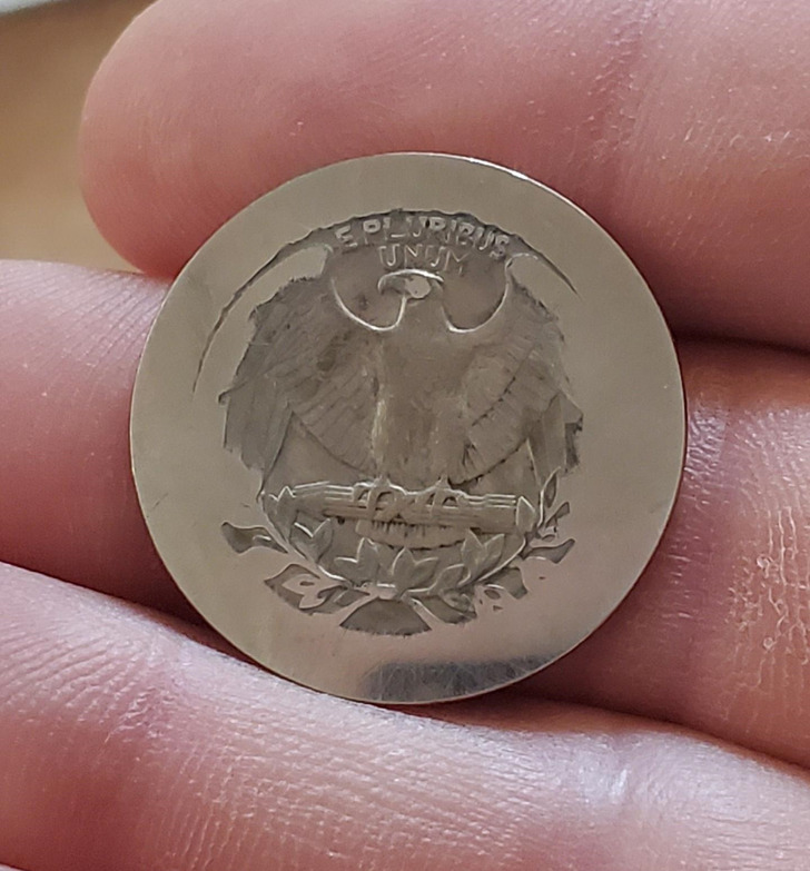 “A quarter that I found underneath the agitator in my washing machine while cleaning it out. Been rubbed smooth after many wash cycles.”