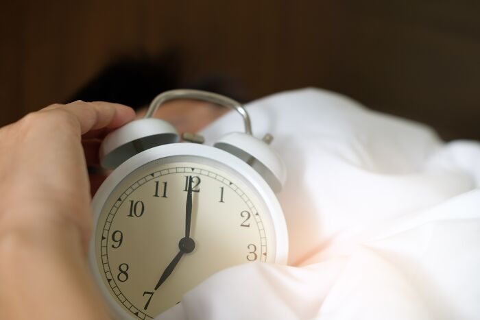 life hacks - person putting an alarm clock - 10 2 au 8