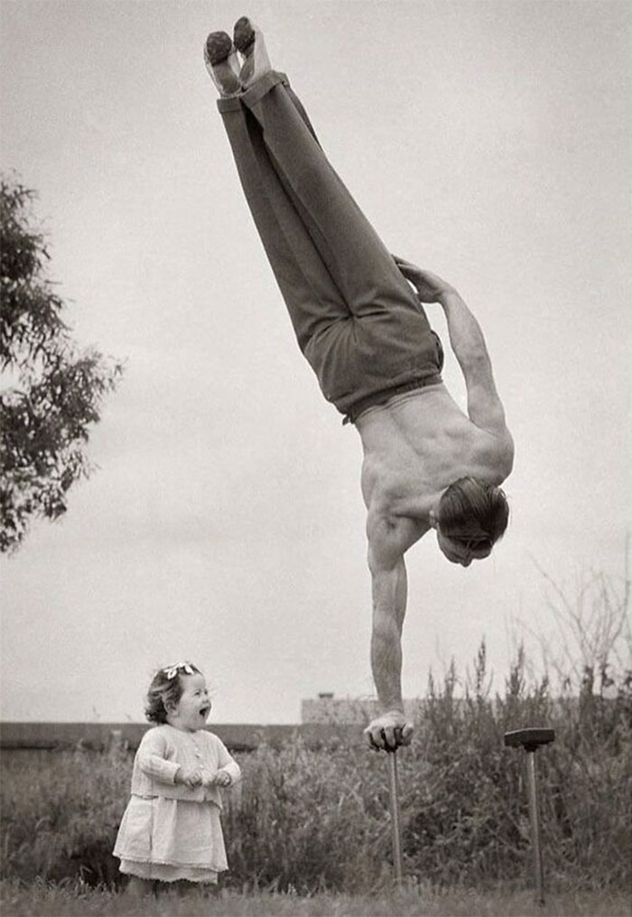 Historical photos - old photos - dad showing off his skill to the surprise of his little daughter in melbourne australia ca 1940s