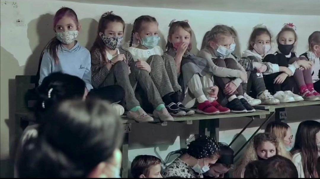 Ukrainian children huddle together in fear in the metro tunnels doubling as air raid shelters