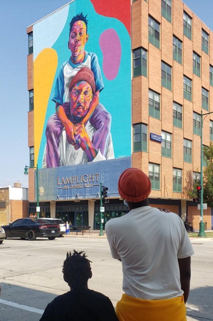 “Father and son looking at the Father and Son mural I painted of them.”