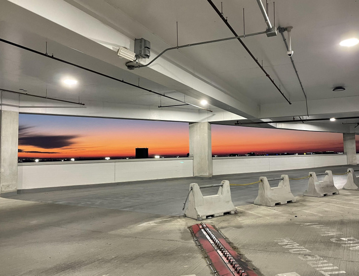 “Saw the sunrise in this parking garage and it almost looks like a mural.”