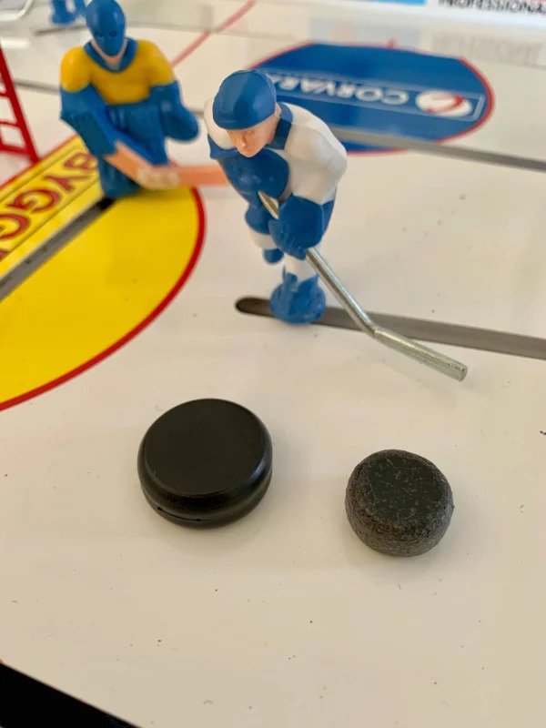 “Table hockey puck after about four and a half years of playing. New one on the left for comparison.”