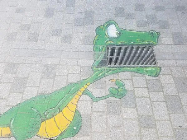 “This street art that uses drainage holes as part of the drawing.”