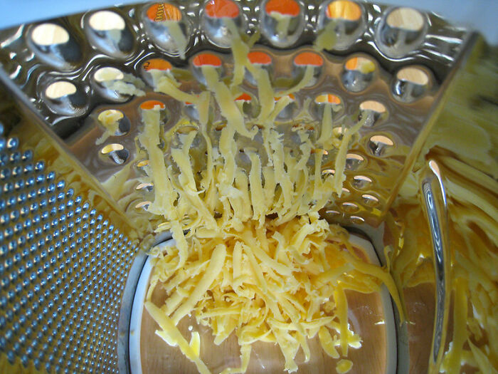 Freshly grated sharp cheddar cheese is better than store bought grated cheese and the difference is noticeable in the meal, especially in tacos