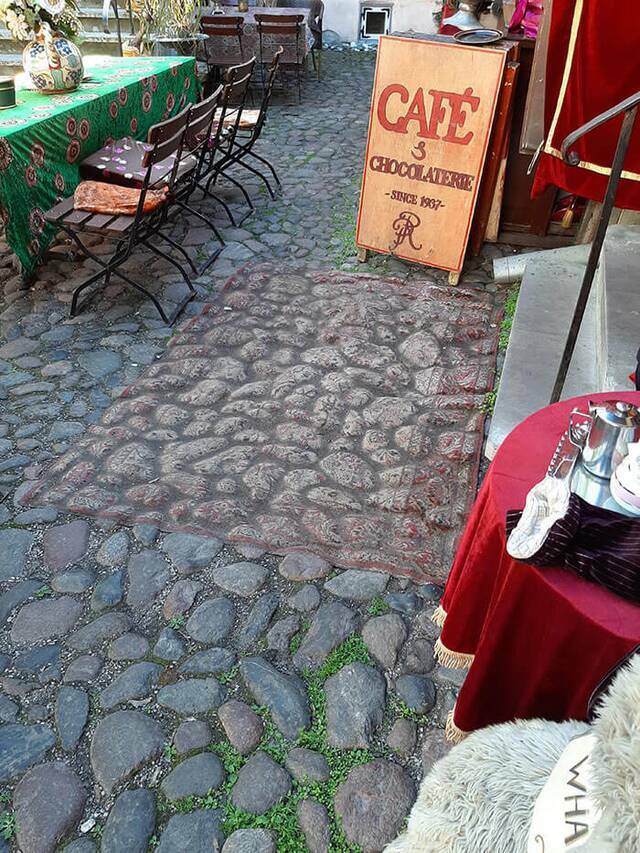 "This rug outside a Cafe is so old, you can mistake it for the ground. It's been there since 1937."