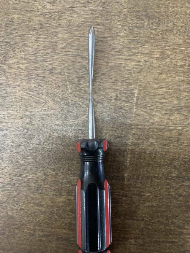 "This screwdriver that has been worn down from years of scraping grip tape at a skate shop."