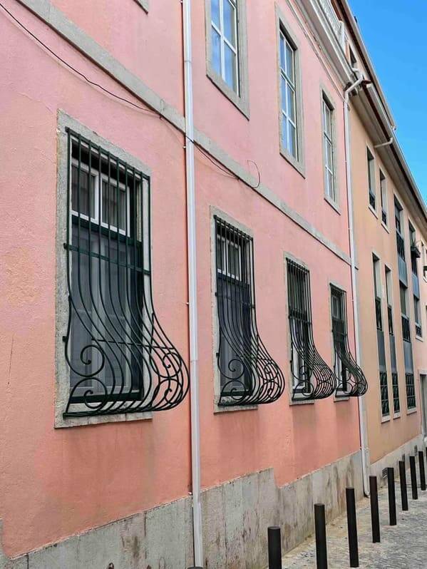 "Why do these window grills have a bulge? Seen in Spain."<br/><br/>

"They’re called “belly bars” in a lot of places. They’re designed for flower boxes."