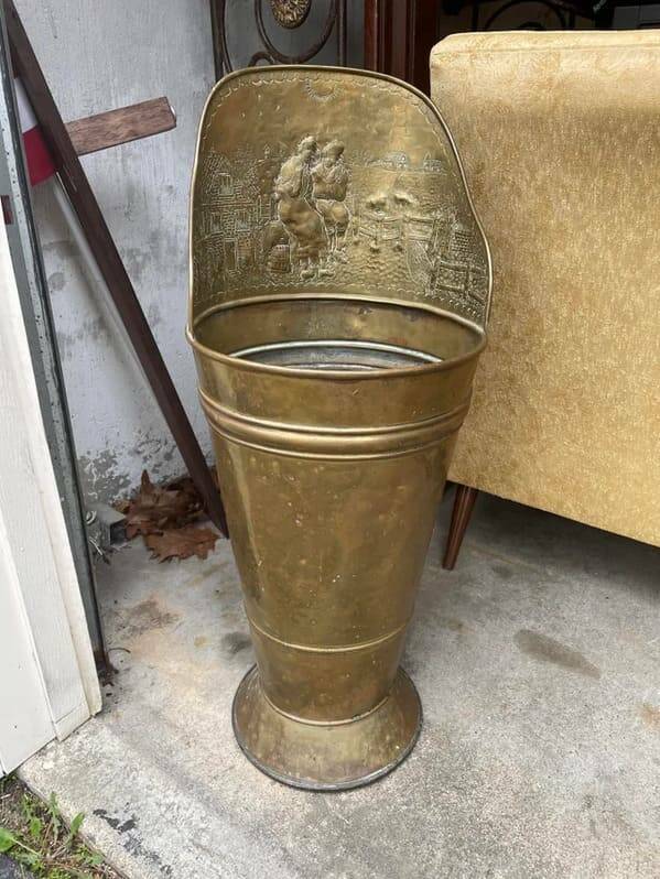 "Found at an estate sale in New Hampshire. About 3 feet tall, gold-colored, but silver inside. Some sort of brackets on the back. Hollow like a bucket, pretty lightweight."
<br/><br/>
"It’s a grape hod. Strap to your back, harvest grapes, this holds grapes in lightweight, leakproof container."