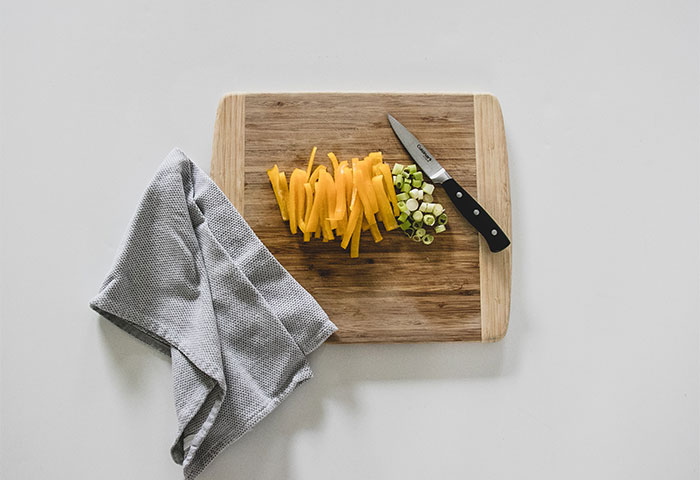 If your cutting board keeps slipping around the counter, put a wet towel or paper towel under it to keep it in its place. It'll make your chopping process much safer than it would be otherwise!