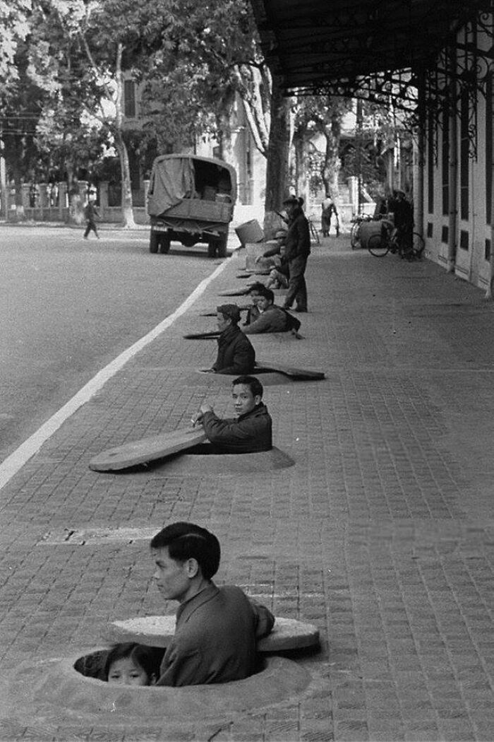 Perfectly Timed Historical Photos - hanoi sidewalk shelter