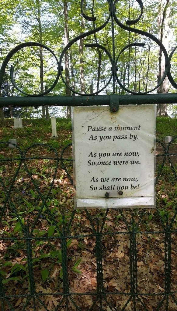 A humbling message outside a cemetery in the middle of the woods