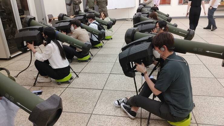 "Civilian employees trying out AT-1K Raybolt ATGM simulators at the Republic of Korea Army Infantry School."