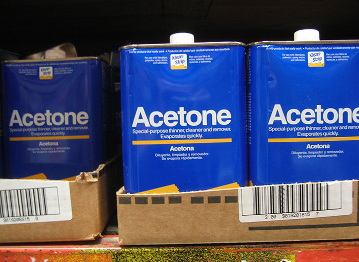 Removing the plastic wrapping from a pallet of 5 gallon cans of (highly flammable) acetone. He didn’t have a box cutter so he proceeded to melt it with a lighter