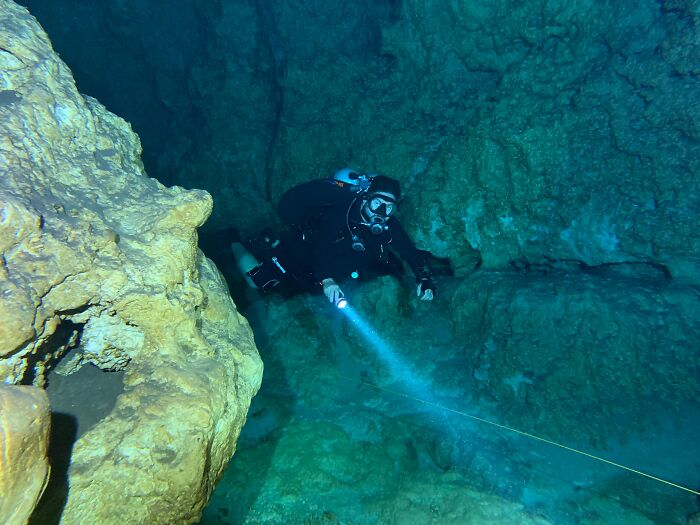 I do a fair bit of cave diving in North Florida and help out with exploration projects. I've got a couple. One is mine, one is a friend's.

So my friend was checking a lead in an offset sink to see if there was any going cave one afternoon. Offset sinks are physically distant from the main cave conduit, so while a primary trunk passage may have lots of clear ground water, an offset sink won't get much water circulation, so rainwater and runoff will tend to stay there for a long time. They're typically very murky and brown, clearing as you approach main cave passage. He's about 100ft in at a depth of 40 or 50ft. Nothing insane, but it's braille diving. Trying to feel his way around while running a line to see if anything goes. He comes across a wall about a foot in front of him that looks a bit unique. Often times you'll see cool patterns of mineral buildup in cave walls/floors/ceilings. So he's appreciating this cool pattern when that pattern opens its mouth and shows off its teeth and tongue. Turns out a not insignificantly sized gator lived in that sink and wasn't happy about the home invasion. He set a new speed record getting back to the surface of that particular sink. Gators aren't uncommon down there and they usually leave you alone, but not when you get that close to them in their own territory.

My story was a bit less exciting but pretty somber. I was doing a dive in the back of a fairly regularly traveled cave system, but in an area where a body had been recovered from about a mile back the week prior. That area isn't as regularly dived due to the logistics and cave passage geometry. It's not a small dive to get back there. The recovery was really challenging and there were signs of damage to the cave as we swam along where the body had been forced through restrictions, through mud, etc. But the real reality check came when we found his mask in the mud several thousand feet back. It had been dislodged (along with his nose) while the recovery divers tried to force him through a small area. It really drove home the reality of where I was and what I was doing and the respect necessary for the environment.