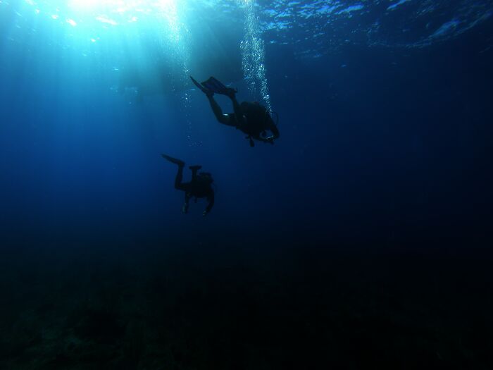 Scuba Diving in Vanuatu on the President Coolidge, very famous wreck dive that you can walk from the shore and dive the bow from 15 meters all the way down to 70 meters.
I was 14 at the time and my parents were life long divers, we dived the Coolidge twice that day already and our guide offered a night dive to us.
We were supposed to only dive down to a depth of 25 meters and check out these flashlight fish that would school together in a cargo hold, they had these really bright green eyes that looked amazing and lit up underwater. I still don’t really know what happened that night but it felt like we were staring at these fish for forever. Suddenly I didn’t feel right, my breathing felt funny, I tried to grab my gauge to check how much air I had left, it took every bit of muscle I had to reach for my gauge connected to my waist, I slowly grabbed it and read that I had about half a tank left, relived for a split second but still concerned something was wrong I reached for my mum to signal her something wasn’t right, I grabbed her arm but couldn’t hold on, I just started sinking to the bottom. My mum quickly grabbed my arm as I fell but I had no leg movement, so I started dragging her to the bottom with me, my dad now realises somethings wrong and grabs my mum trying to pull us all up. The dive guide now is freaking out and trying to make sure everyone is alright, they all start swimming me back up and in to shore. Once we got up closer, I started to feel normal again but abit dazed and confused. Turns out I had nitrogen narcosis, and had dropped to 40 meters when I couldn’t swim anymore. For those of you who don’t know what nitrogen narcosis is, it’s when you have to much nitrogen in your body and it gives you a intoxicated effect.
Nothing to hectic but still a vivid memory of thinking I was gonna sink to the bottom of the ocean not being able to do anything about it.