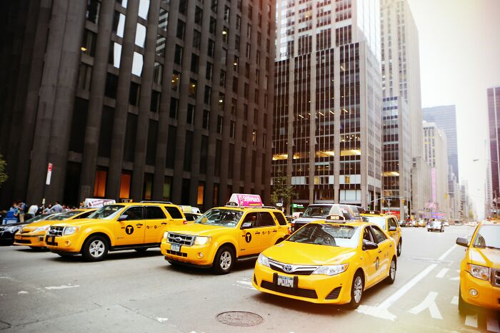 I'm from New York City.

Taxi drivers here are HUGE con artists. HUGE.

They will deliberately take the longest and most complicated route to get to the location. They will deliberately drive into the worst traffic and worst road construction in the city. The longer the ride, the more they get paid.

My advice: Look at a map before you get into the cab. Figure out how to get there. Know the shortest route. As soon as you get in, tell him EXACTLY how you want to get there. If he tells you "Oh, this other way is faster", don't believe him. He is probably a big fat liar. Give him exact directions and don't let him give you any "suggestions."

If he drives you into traffic, immediately get out and find another taxi, if possible.