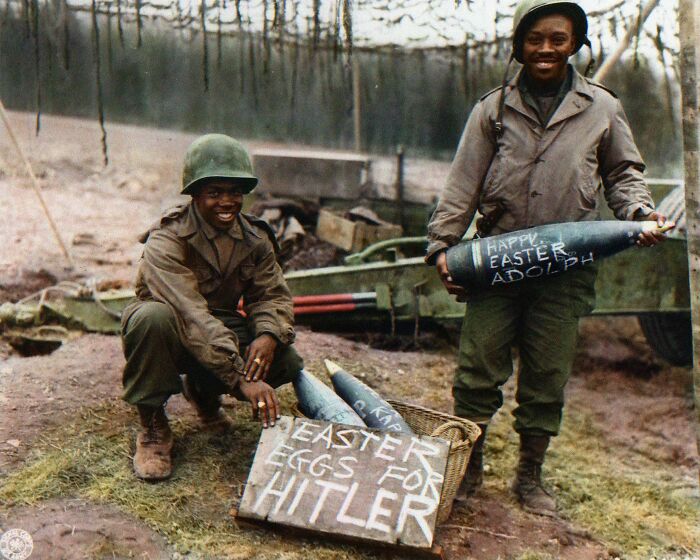 colorized photos from history - Two American Soldiers Proudly Show Off Their Personalized "Easter Eggs" (155mm Artillery Shells) Made Especially For Adolf Hitler, 1945