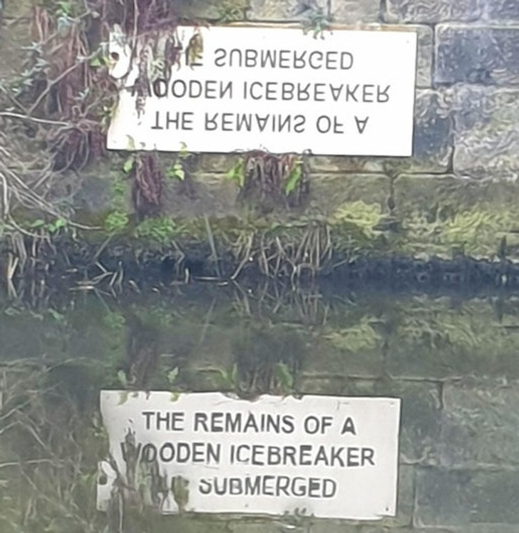 “This sign was designed to be read in the reflection of the water.”