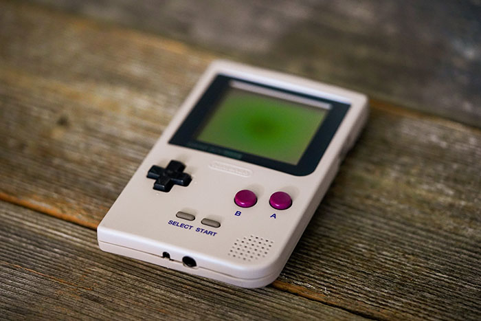 A senior in my high school got the school district's rules and guidelines updated to ban handheld video game devices specifically.

He got in a massive argument with a teacher when that teacher took his Game Boy Color from him. She manhandled it, almost broke it, and he cussed her out and got suspended.

When he went to the principal's office to retrieve his GBC, the student insisted there was no rule forbidding the presence of video games on campus. The principal cited a rule about music devices, pagers, and cellphones ("noise making devices") and said it also applied to video games. The student asked to see a her copy of the book of rules and guidelines, saying his copy didn't include the rule about video games. When the principal was unable to even produce a copy of the rulebook, the student openly mocked her.

Video games were officially banned by the beginning of the next year, after he graduated.

That student was me.