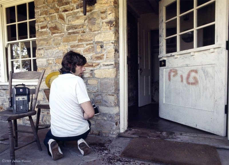 Roman Polanski kneeling at his door where ‘Pig’ is written in his wife’s blood (Sharon Tate) after the Manson family murders.