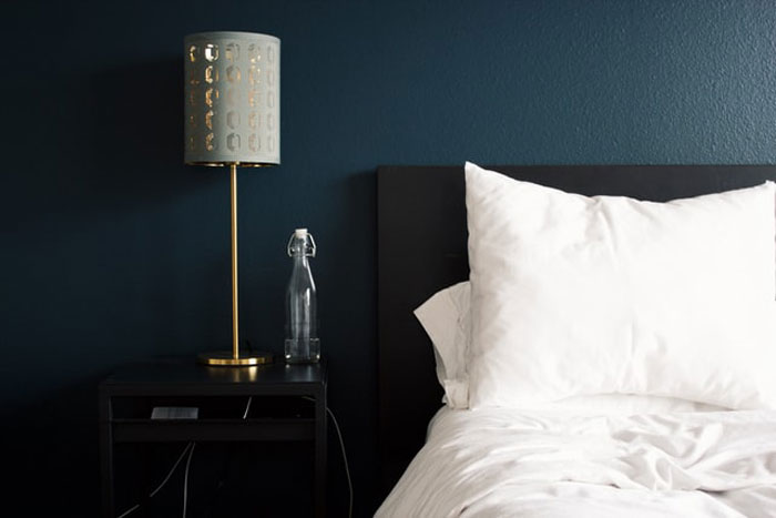 A room can have bedbugs even if you see no evidence of them on the mattress itself. If it's not attached to the wall, looking on the backside of the headboard is always a good idea.
