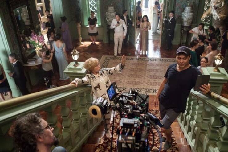 behind the scenes movies - And director Jon M. Chu sets up the big party entrance scene with Awkwafina on the set of Crazy Rich Asians (2018).