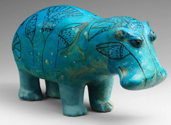 that there are around 50-60 blue faience hippopotamus statuettes that survived from Ancient Egypt. Due to the danger hippos posed in the wild, they often snapped off the legs of hippopotamus statuettes before placing them in tombs, so the hippos wouldn’t be able to eat the soul of the deceased.