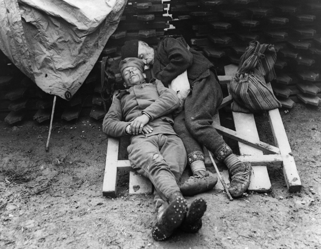 A Serbian soldier sleeps with his father who came to visit him on the front line near Belgrade, 1914