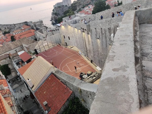 basketball court against 700 year old walls