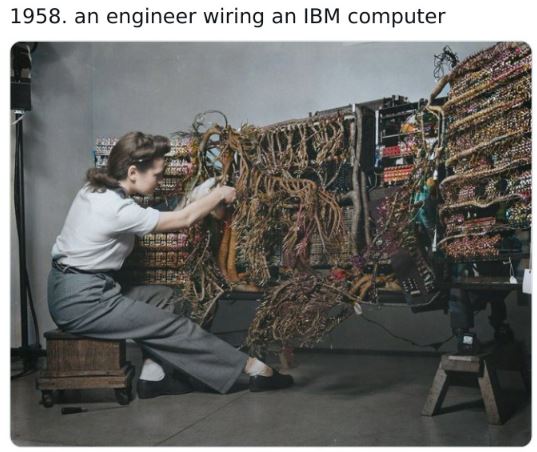 colorized historical photos - woman wiring an early ibm computer berenice abbott - 1958. an engineer wiring an Ibm computer