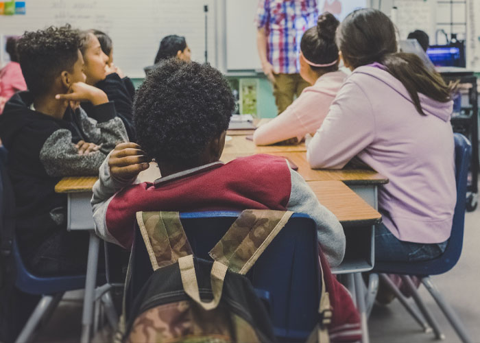 In grade school we had desk in rows, I was part of the group in the back these were 6 kids side-by-side. I was leaning backwards in my chair and felt myself falling as I ended up leaning too far. I tried to grab the two kids next to me for support and pulled them off balance since they ware also kinda leaning back, comically I remember one of them reached out and pulled yet another kid down.