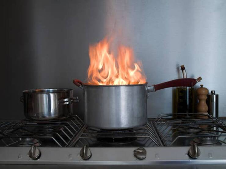 "Put a lid on a flaming pan to smother it and remove from heat carefully. Never throw any liquid on it. Don't remove the lid for at least 5 minutes."