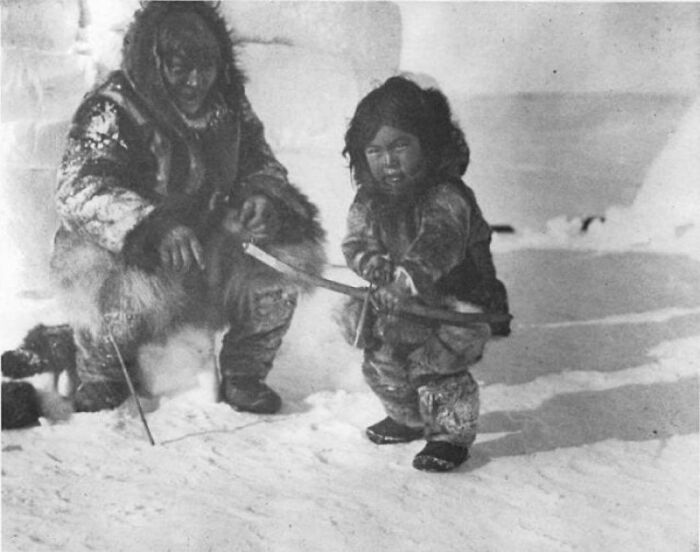 historical pictures - Inuk Man Teaching A Boy How To Shoot. Circa 1920