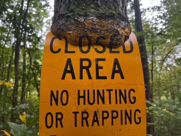 awesome finds - cool things people found - sign - Closed Area No Hunting Or Trapping