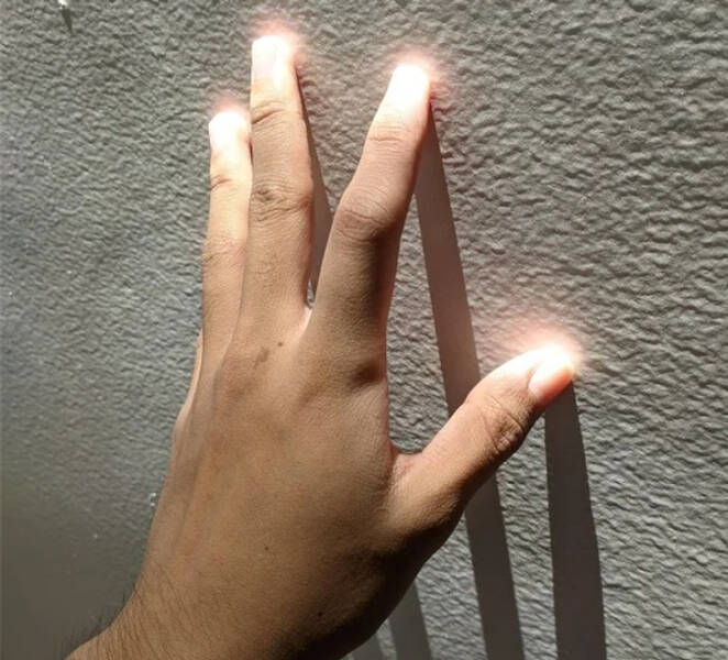 “My fingertips glow when touching this wall.”