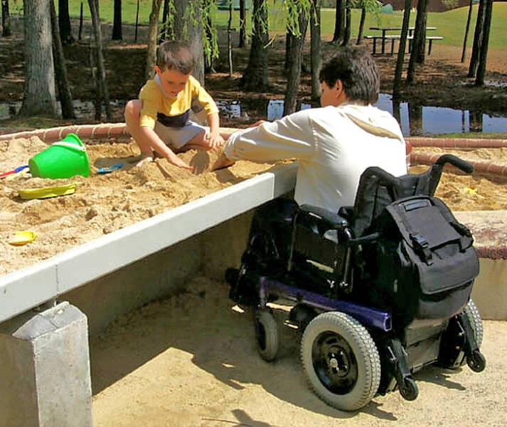 "A sandbox that allows wheelchair users to play in it"