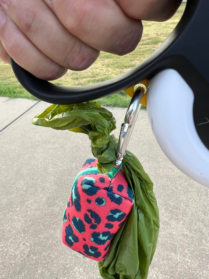 “To avoid having to carry the dog poo bag, flip the carabiner used to secure your baggies so that the small end is down low. Tie a big knot in the bag, and pop it through the carabiner.”